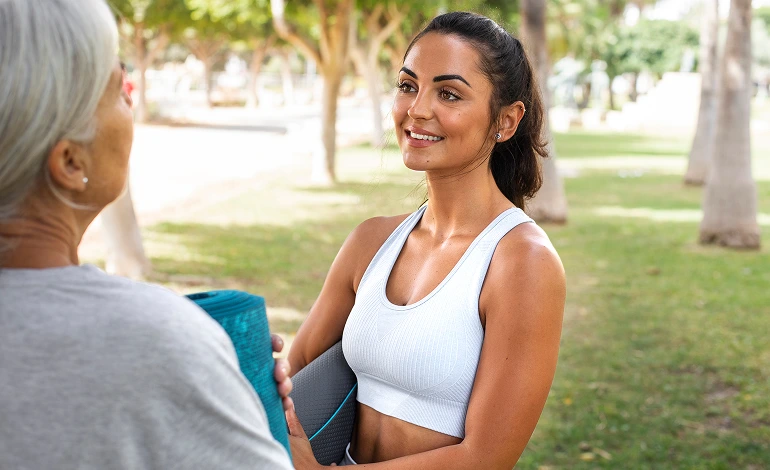lady in sports apparel taking to the elderly